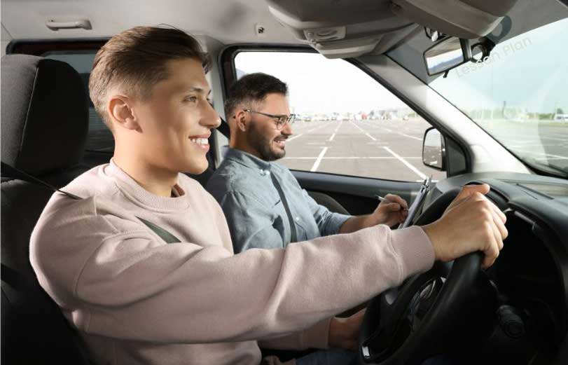 A driving instructor planning during a lesson